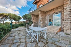 a table and chairs on the patio of a house at Il Cavo Suites - Elba Affitti in Cavo