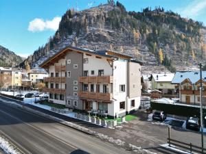 a view of a town with a mountain in the background at Liz Hotel & Apartments in Predazzo