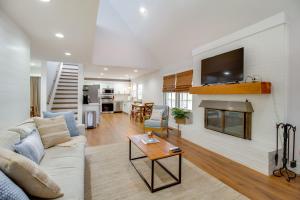 a living room with a couch and a fireplace at 2 Mi to Tims Ford Lake! Cozy Cottage with Fireplace in Winchester