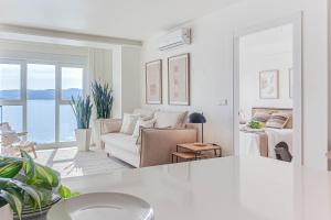 a white living room with a couch and a bed at Blue Ocean Deluxe in Sanxenxo