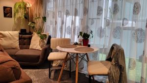 a living room with a table and a couch at Stylish Home within Central Wellington - Free Parking in Wellington