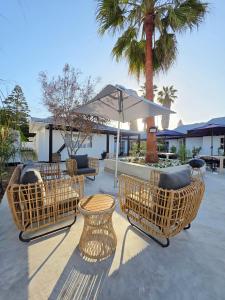 White Cottage Boutique Guesthouse في سواكوبموند: فناء فيه كراسي وطاولة ومظلة