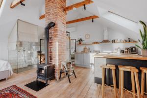 a kitchen and living room with a brick fireplace at Haapsalu home by the sea in Haapsalu
