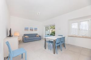 a living room with a table and chairs and a couch at Il Cavo Suites - Elba Affitti in Cavo +23 photos