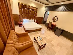 a hotel room with a bed and a couch at Blue Moon Residency Jinnah Super in Islamabad