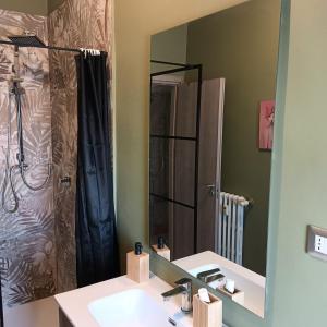 un bagno con lavandino, doccia e specchio di Accogliente e comoda Casa Rampa a Campobasso