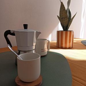 una macchinetta del caffè e una tazza sul tavolo di Accogliente e comoda Casa Rampa a Campobasso Altre 6 foto