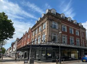 a large brick building on a city street at Elysée Suites - Lovely 2 Bed Flat in Southport in Southport