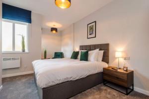 a bedroom with a large bed and a window at Elysée Suites - Lovely 2 Bed Flat in Southport in Southport