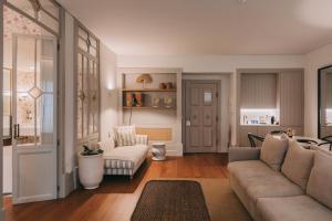 a living room with a couch and a chair at Torel Saboaria in Porto