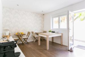 a dining room with a table and chairs and a window at Albufeira Solmare Suites in Albufeira