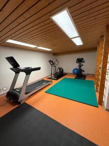 a gym with three exercise bikes and a treadmill at Monolocale in centro, Piscina e 400mt da Skilift in St. Moritz
