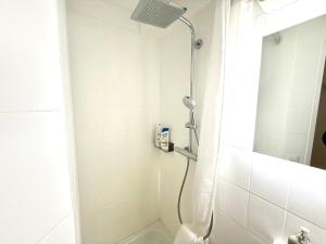 a bathroom with a shower with a shower head at Monolocale in centro, Piscina e 400mt da Skilift in St. Moritz