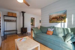 a living room with a blue couch and a table at Lakeside & Private dock - Le Suisse d-Entrelacs in Entrelacs