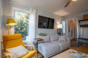 a living room with a couch and a window at Lakeside & Private dock - Le Suisse d-Entrelacs in Entrelacs