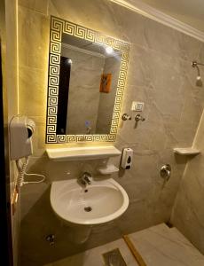 a bathroom with a sink and a mirror at Amer Group Villas and Chalets on the Pool in Ain Sokhna