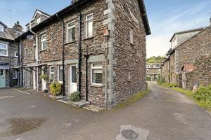 an old brick house with a street in front of it at Rydal View Cottage in Ambleside
