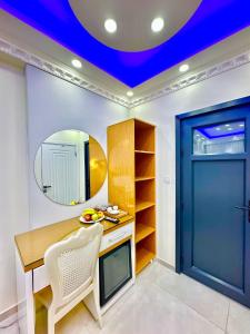 a room with a desk and a mirror and a blue ceiling at Hagia Sophia Palace Hotel in Istanbul