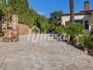 an image of a stone driveway in front of a house at Villa Paradise in Calonge