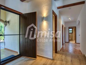 a corridor of a house with a glass door at Villa Paradise in Calonge