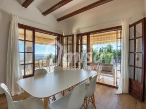 a table and chairs in a dining room with a view at Villa Paradise in Calonge +17 photos