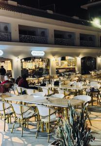 a restaurant with tables and chairs and people sitting at them at Amer Group Villas and Chalets on the Pool in Ain Sokhna +68 photos