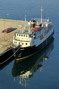a large boat is docked in the water at Lofoten Cruise & Hotel in Svolvær