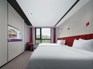 Ένα ή περισσότερα κρεβάτια σε δωμάτιο στο Mercure Beijing The Grand Canal CBD
