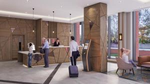 eine Gruppe von Personen, die in einer Lobby mit Gepäck stehen in der Unterkunft Maldron Hotel Croke Park in Dublin