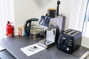 a kitchen counter with a blender and a toaster at Modern 4-Bed Retreat in Prestwich, Perfect for Weekend Getaways in Manchester