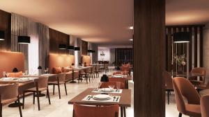 a dining room with tables and chairs and tablesktop at Hotel Livata Mountain & Wellness in Subiaco