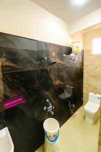 a bathroom with a sink and a toilet at Hotel Tirupati Residency Ujjain # Near Mahakal Mandir And Railway Station # Top rated in Ujjain