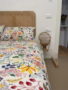 a bedroom with a bed with a colorful bedspread at DieciVasi in Ravenna +46 photos