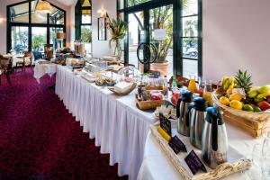 a long table with food on it in a restaurant at Excelsior in Saint-Raphaël