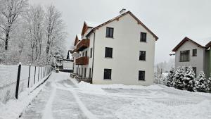 a house is covered in snow at Holiday Karpacz in Karpacz