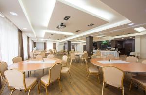 a large room with tables and chairs and a cafeteria at Hotel Lučivná in Lučivná