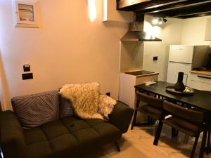 a living room with a couch and a table and a kitchen at NEKTAR home in Latsídha