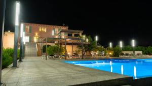 a swimming pool in front of a building at night at Villa Sa Muntanyeta con Piscina Infinity Privada in Manacor