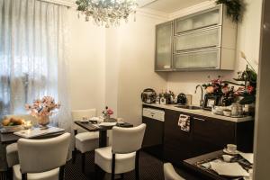 uma cozinha com uma mesa e cadeiras e um lavatório em Hotel Garni Villa Arrisja em Eefde mais 32 fotografias