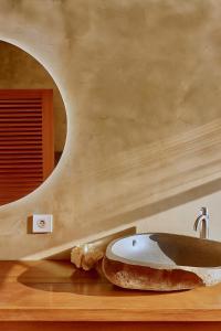 a bathroom with a sink and a donut on a counter at Villa Luzo & Tours in Saonek