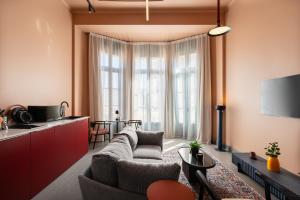 a living room with a couch and a table at grey l studio apartments Downtown Cairo Bidair House in Cairo