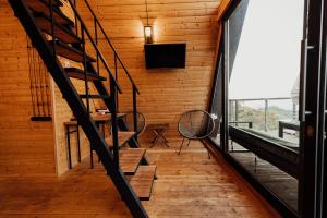 a staircase in a room with a large window at Nutshell in Sakhalvasho