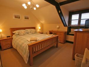 En eller flere senge i et værelse på Miller's Cottage