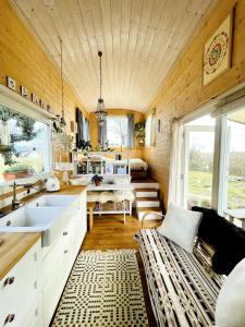 una cucina con lavandino e un divano in una camera di Tiny House Elsass - Natur, Ruhe & Erholung a Saint-Pierre-Bois Altre 26 foto