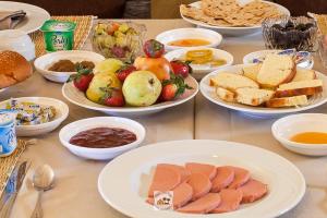 a table with plates of food and bowls of food at merzouga stars luxury camp in Merzouga