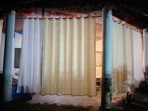a window with white curtains in a room at Daijan villa in Ukunda