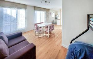 a living room with a couch and a table at Cozy Apartment In Dunkerque in Dunkerque