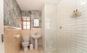a bathroom with a toilet and a sink at A Whale of a Time Knysna in Knysna