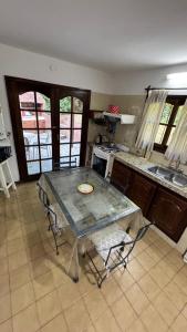 a kitchen with a table and some chairs in it at Casa Calamar I in Valeria del Mar