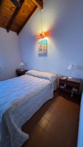 a bedroom with two beds and a painting on the wall at Casa Calamar I in Valeria del Mar